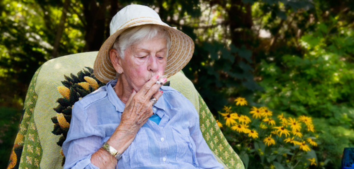 Happy senior woman smoking marijuana