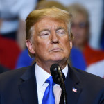 President Donald Trump with a serious look as he delivers a speech at a campaign rally held at the Mohegan Sun Arena.