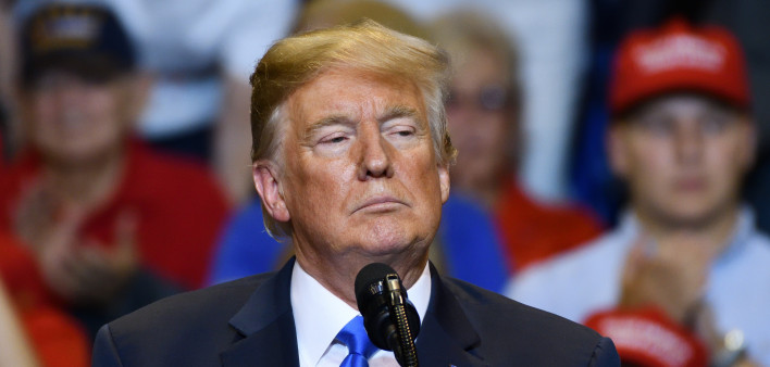President Donald Trump with a serious look as he delivers a speech at a campaign rally held at the Mohegan Sun Arena.