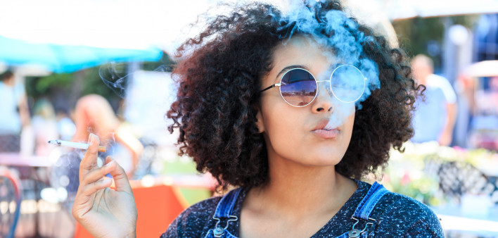 African American woman smoking in cafeteria