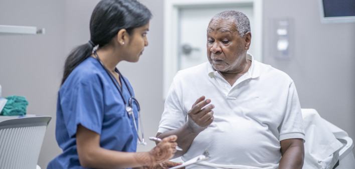 nurse talking to black doctor