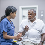 nurse talking to black doctor