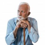 elderly man sitting leaning on his cane