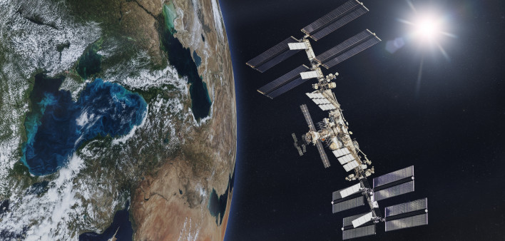 International Space Station on low-orbit of Earth with rising Sun. Elements of this image furnished by NASA.