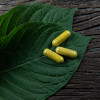 Kratom leaves and capsules