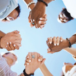 group of people holding hand to form a circle support