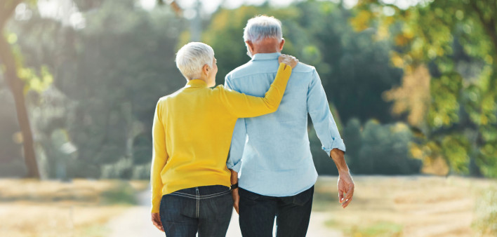 elderly couple walking in the park