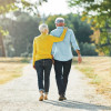 elderly couple walking in the park