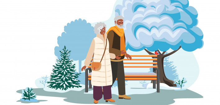 elderly black couple walking in the park in the winter