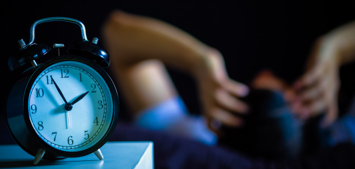 Asian man in bed suffering insomnia and sleep disorder thinking about his problem at night