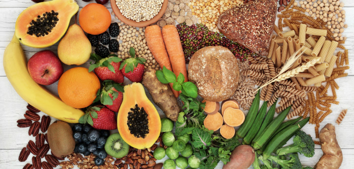 food with high fiber content for a healthy diet with fruit, vegetables, whole wheat bread, pasta, nuts, legumes, grains and cereals