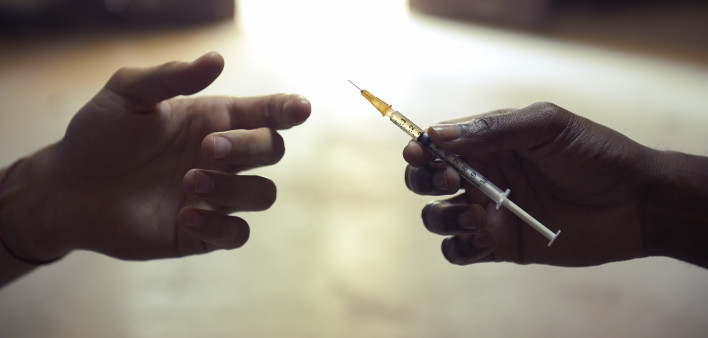 drug users passing a syringe