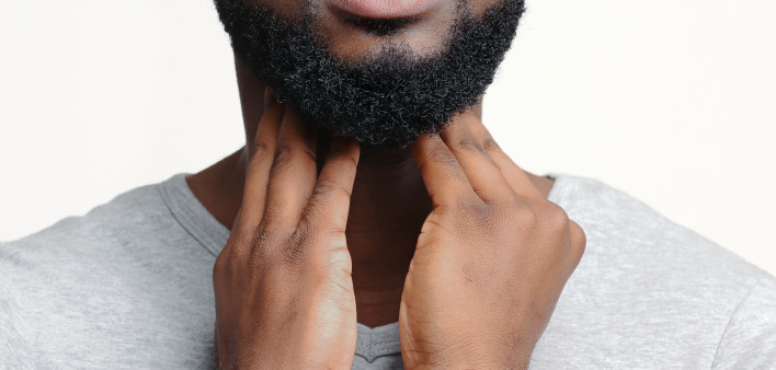 man holding throat thyroid black man