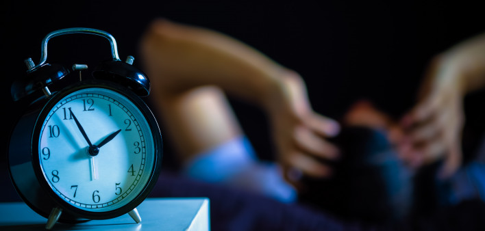 Asian man in bed suffering insomnia and sleep disorder thinking about his problem at night
