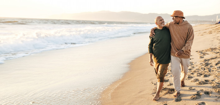 gay couple walking on the beach