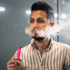 Young latino man e-cigarette smoking
