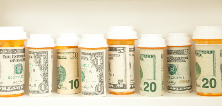 pill bottles with money as labels cost of healthcare