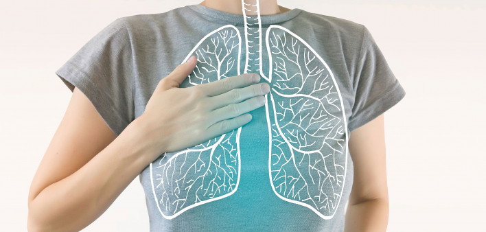 woman holding chest diagram of lungs