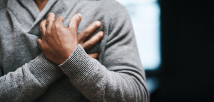 African American Man holding chest pain heart