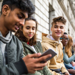Teenagers students using smartphone on a school break