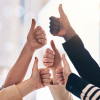group of arms and hands with thumbs up