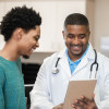 Doctor and patient looking at digital tablet in exam