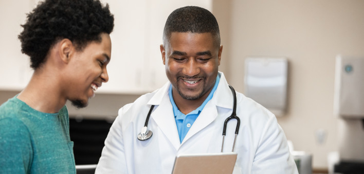 Doctor and patient looking at digital tablet in exam