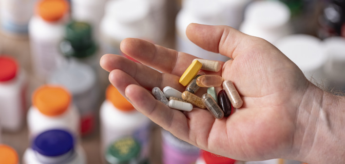 hand holding vitamins and supplements