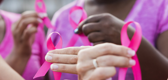 Multi-ethnic women with breast cancer awareness ribbons