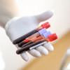 female medical worker holding blood vials after a blood donation