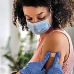Nurse giving vaccine to patient