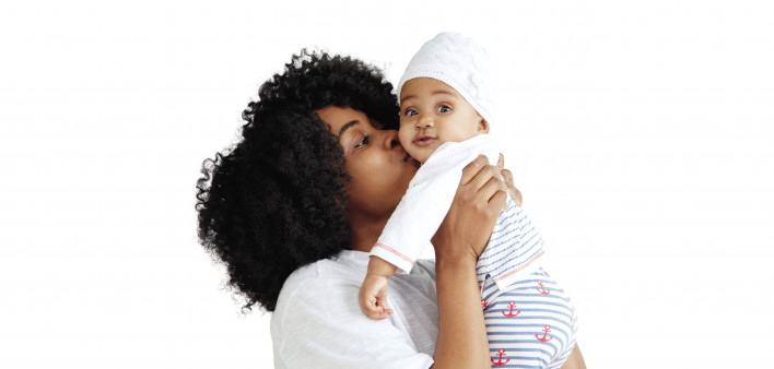 black woman holding and kissing baby