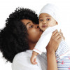 black woman holding and kissing baby