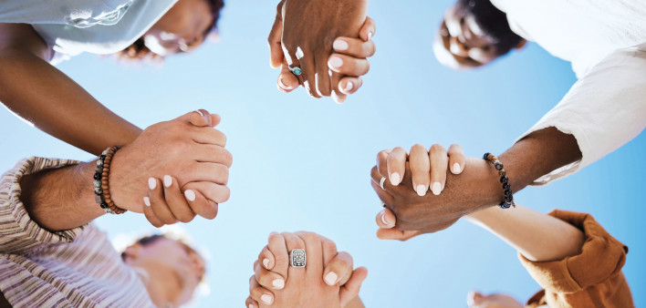 group of people holding hand to form a circle support