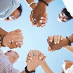 group of people holding hand to form a circle support
