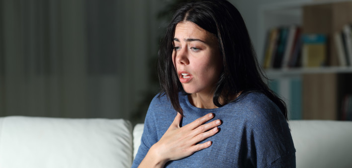 Woman suffering an anxiety attack alone in the night