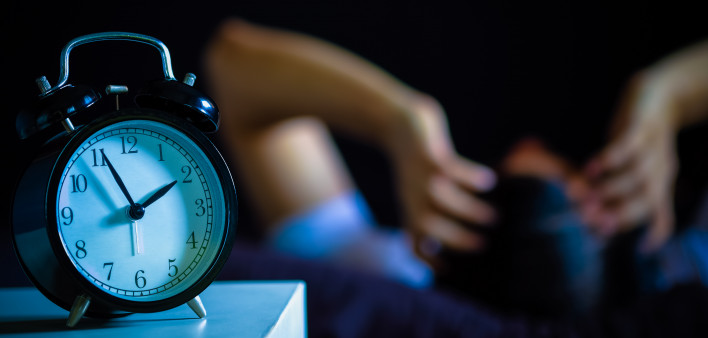 Asian man in bed suffering insomnia and sleep disorder thinking about his problem at night