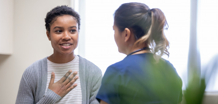 Nurse explaining good news to female patient