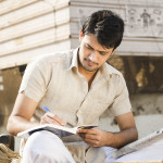 man taking notes writing in journal