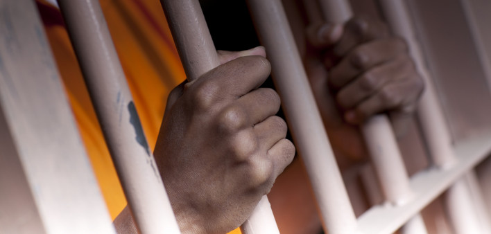 Prison Prisoner Prison Reform hands on bars