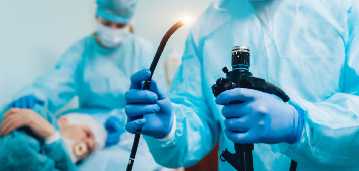 Endoscopy at the hospital. Doctor holding endoscope before gastroscopy stock photo Colonoscopy, Endoscope, Esophagus, Doctor, Patient