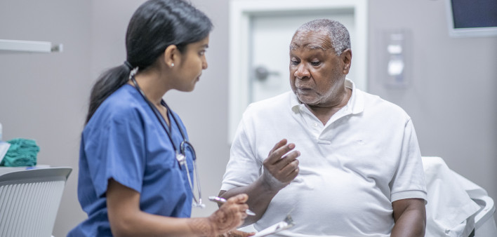 nurse talking to black doctor