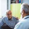 Doctor with x-rays and smiling old man patient