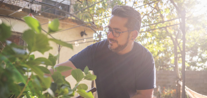 A healthy Latino man living with HIV in the garden
