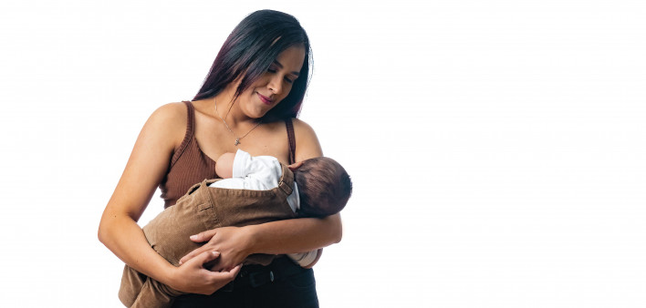 woman nursing her baby holding baby