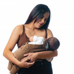 woman nursing her baby holding baby