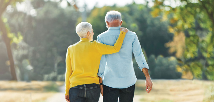 elderly couple walking in the park
