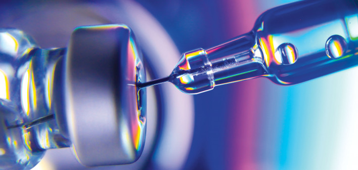 needle going into vial vaccine