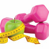 Diet, fitness and sport concept. Pink dumbbell, measuring tape and green apple on white background