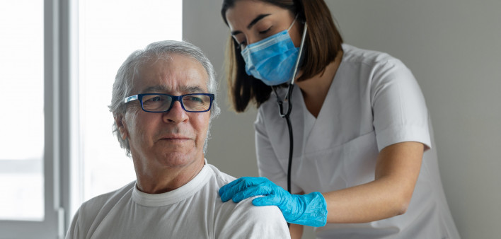 nurse and male pateint listening to lungs